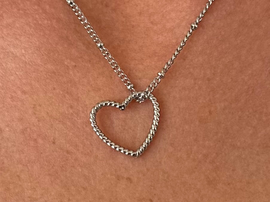 Silver-colored metal necklace with a twisted heart