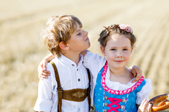 A boy in Lederhosen and a girl in a Dirndl